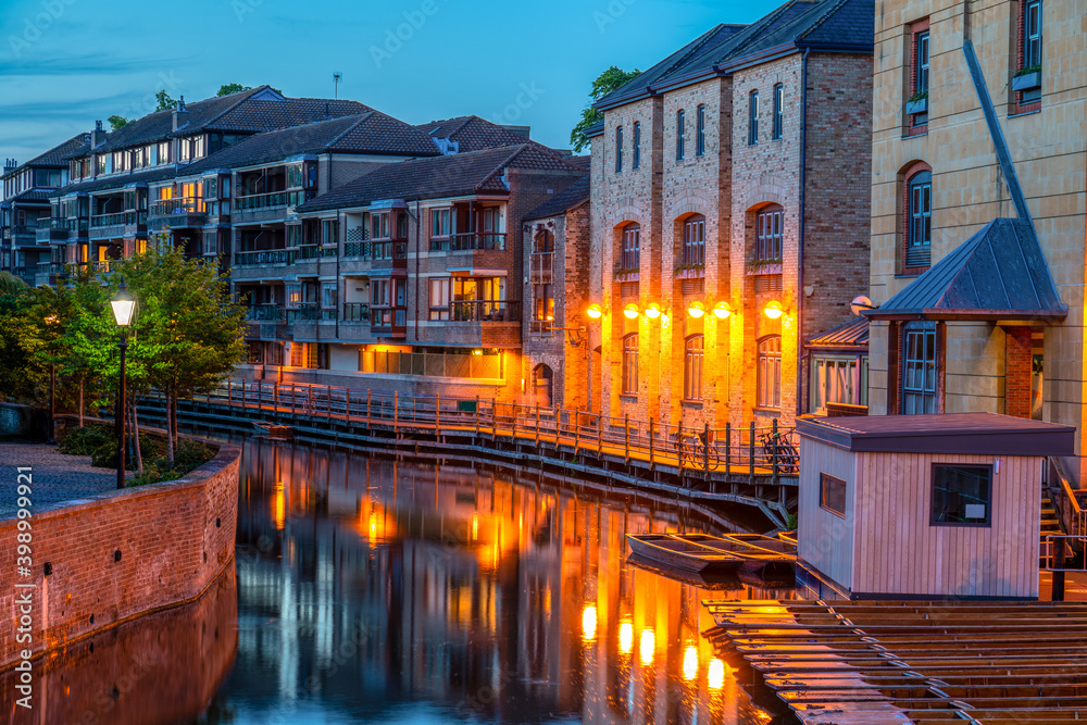 Water canal of river Cam at dusk. Cambridge city in England 