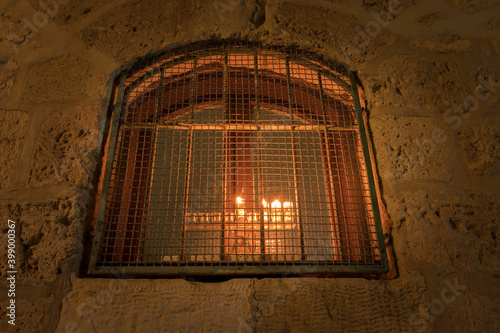 A menorah is lit inside a window, in an ancient house in the Jewish Quarter of the Old City of Jerusalem photo