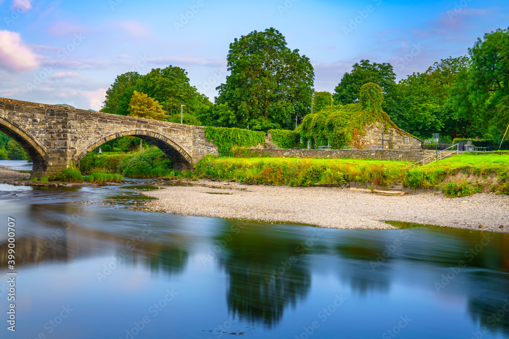 Stone bridge across the river Conwy, and old cottage covered with vine leaves, Llanrwst, Caernarfon, North Wales