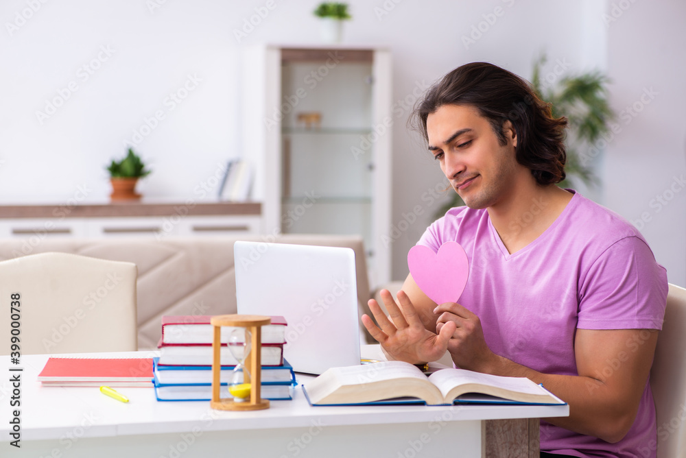 Male student in love preparing for exams in time management conc Male student in love preparing for exams in time management conc