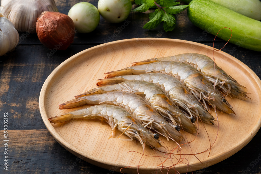 Close up Fresh raw shrimp (Litopenaeus vannamei) on wooden plate Close up Fresh raw shrimp (Litopenaeus vannamei) on wooden plate