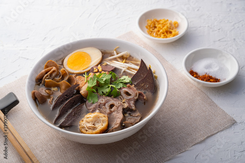 Chinese roll noodle soup with crispy pork. photo