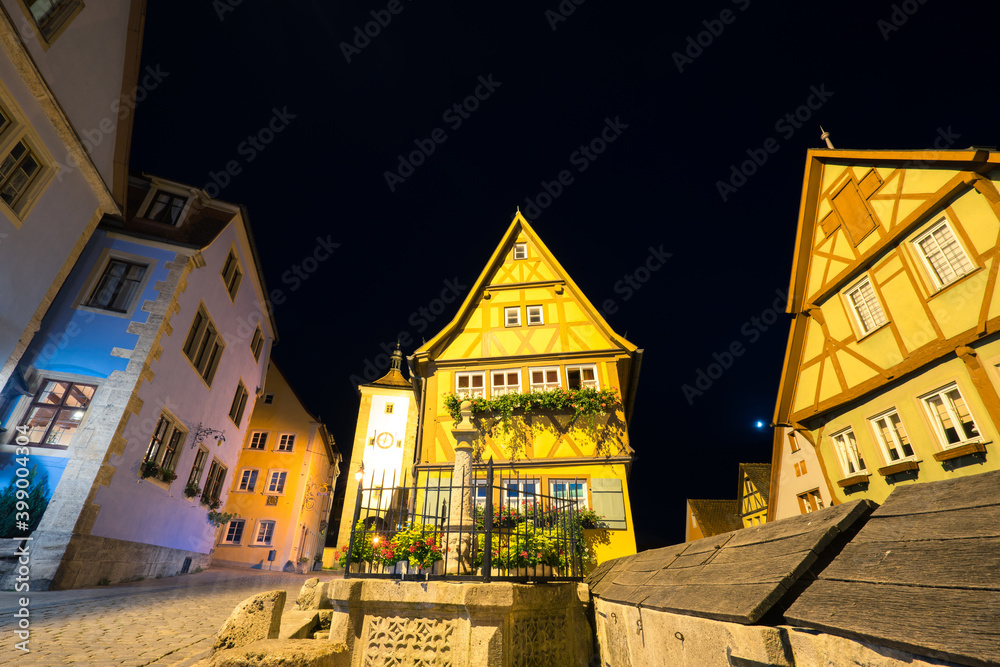 Traditional architecture of Rothenburg ob der Tauber at Untere Schmiedgasse street at night. Germany