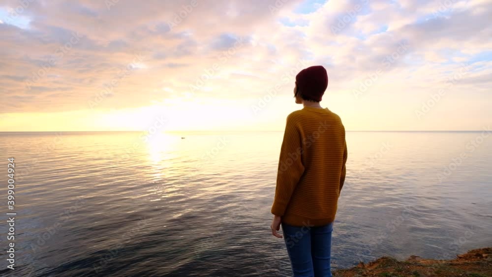 Young beautiful woman in orange sweater in cold weather Young beautiful woman in orange sweater in cold weather