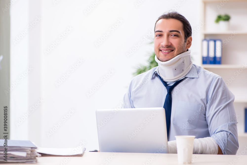 Injured male employee at workplace after accident Injured male employee at workplace after accident