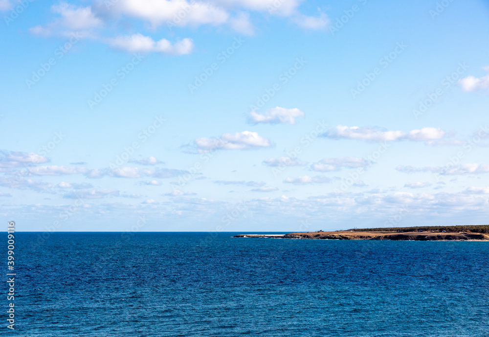 Seascape with clouds and blue sky