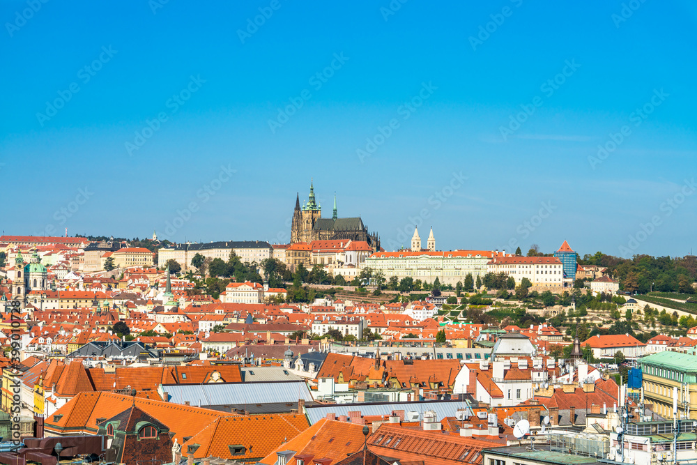 Obraz premium Top view of red roofs and Prague's castle in Czech republic