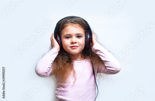 A young girl enjoying listening to music on her headphone