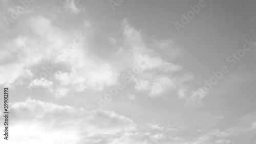 clouds float across the sky, black and white style.