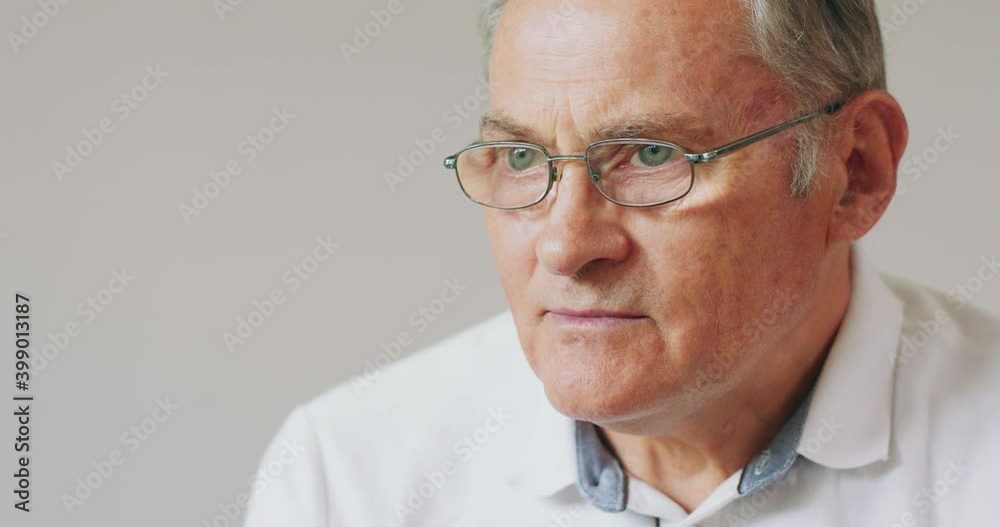 Close-up portrait of a serious, gray-haired, senior man in glasses. Close-up portrait of a serious, gray-haired, senior man in glasses.