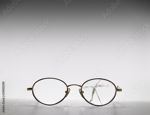 Glasses with a broken lens. Broken Eyeglasses on white background