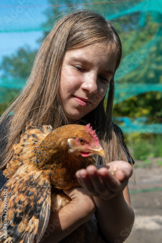 Rural girl with hen.