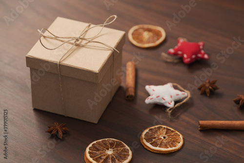 Christmas gift box from eco friendly paper wrapped with natural twine on wood table with natural decorations