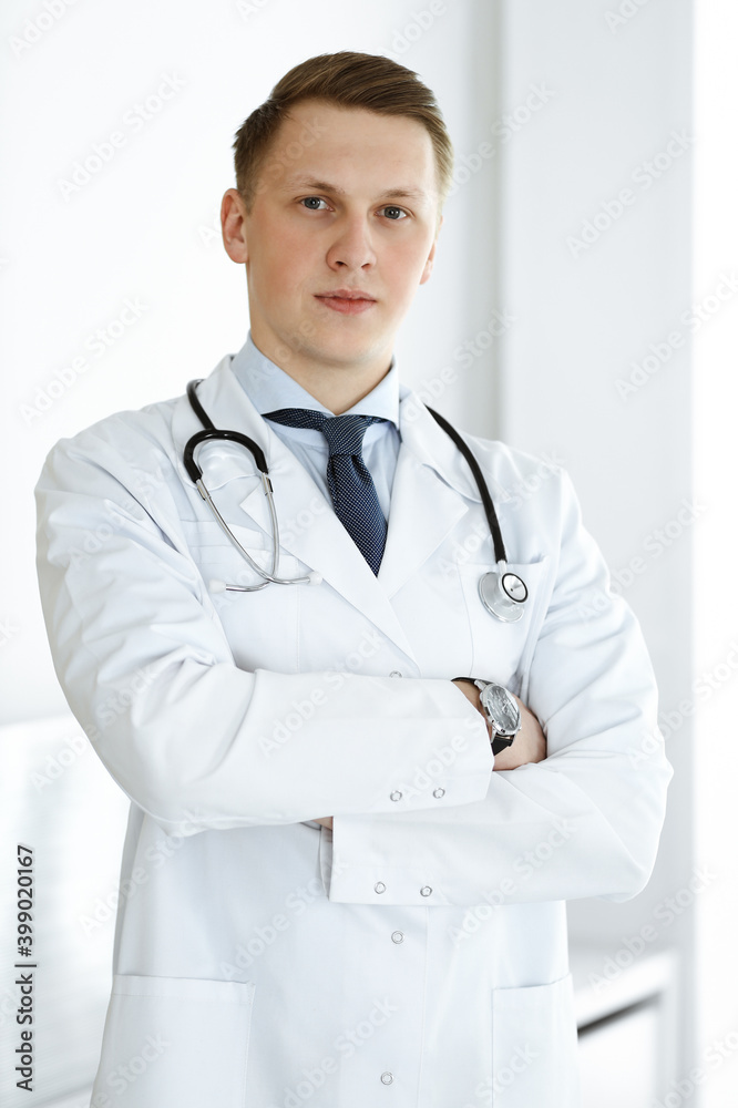 Doctor man standing straight in medical office or clinic. Medicine concept Doctor man standing straight in medical office or clinic. Medicine concept