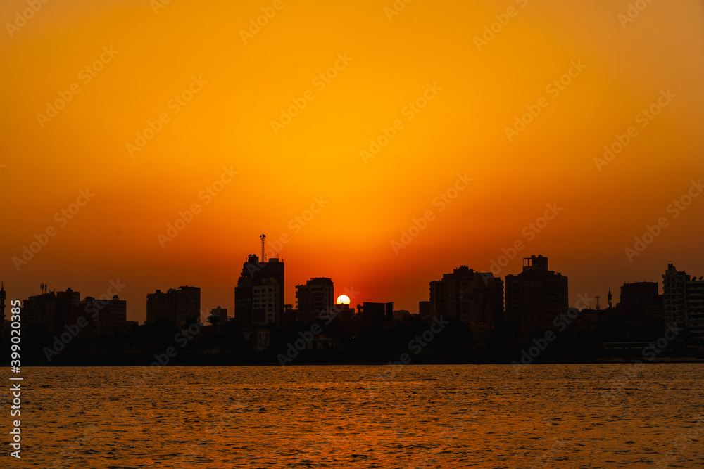Sunset on the skyline of the city of Cairo, the sun goes down on the buildings of the city of Cairo in the background. Africa