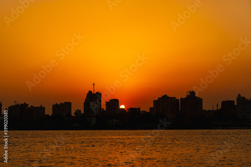 Sunset on the skyline of the city of Cairo, the sun goes down on the buildings of the city of Cairo in the background. Africa © unai