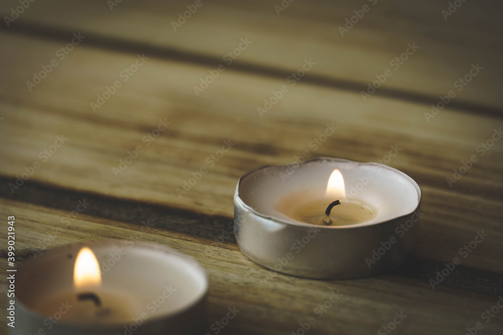 Burning candles with on a wood background, shot with shallow depth of field. Spirituality symbol Burning candles with on a wood background, shot with shallow depth of field. Spirituality symbol