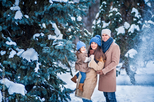 portrait of a family against the background of snow-covered trees