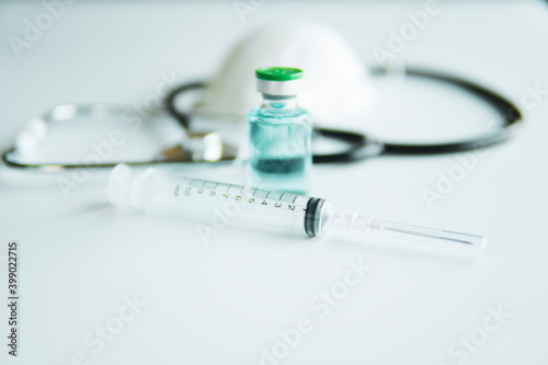 Vaccine Syringe and Medical stethoscope on medical space vaccine corona virus concept