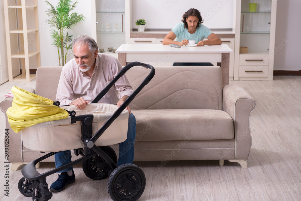 Retired grandfather looking after newborn at home Retired grandfather looking after newborn at home