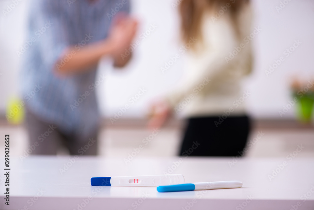 Young couple in unexpected pregnancy concept at home Young couple in unexpected pregnancy concept at home