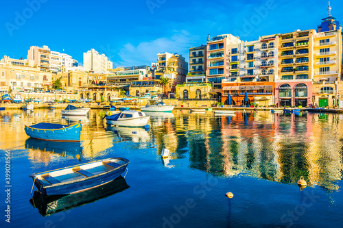 Small fishing boats moored in St Julians and Spinola bay on a sunny day  in St Julians  Malta.