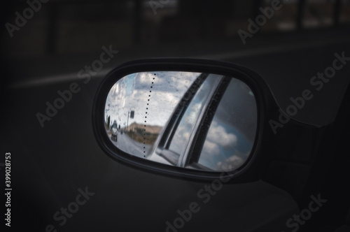 Looking at the road in the rearview mirror.