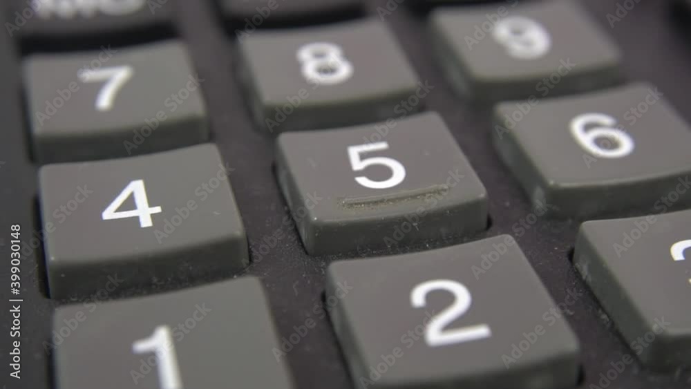 Calculator keyboard close up view. Black calculator buttons, selective focus. A heavily used old accounting engineering calculator with dirt between buttons. Dolly shooting. Calculator keyboard close up view. Black calculator buttons, selective focus. A heavily used old accounting engineering calculator with dirt between buttons. Dolly shooting.