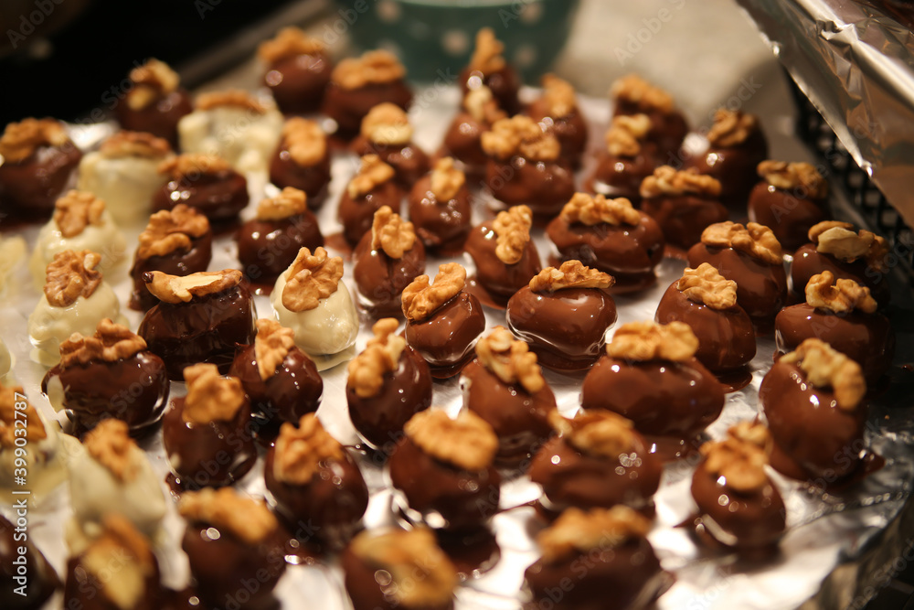 Close up of tray in german kitchen with group fresh homemade shiny fig walnut marzipan pralines Close up of tray in german kitchen with group fresh homemade shiny fig walnut marzipan pralines
