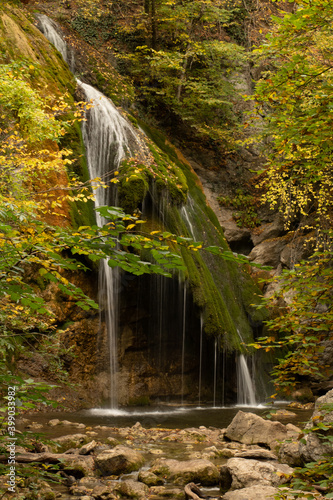 Autumn mountain waterfall view. Forestl in autumn mountains. Autumn forest in mountains. Autumn mountain landscape