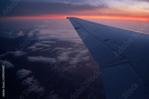 Aircraft wing from passenger cabin at evening