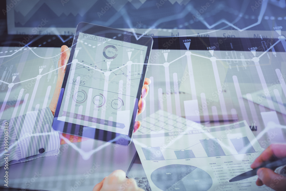 Double exposure of man's hands holding and using a digital device and forex graph drawing. Financial market concept. Double exposure of man's hands holding and using a digital device and forex graph drawing. Financial market concept.