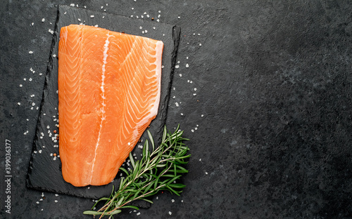 salmon fillet with spices on a stone background with copy space for your text