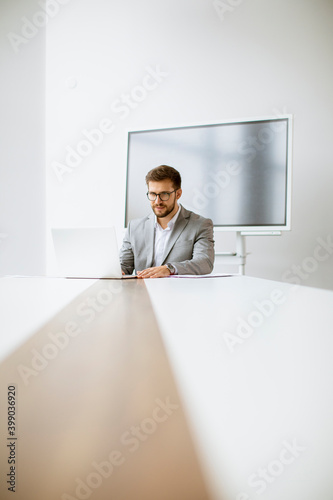 Young man working on laptop...