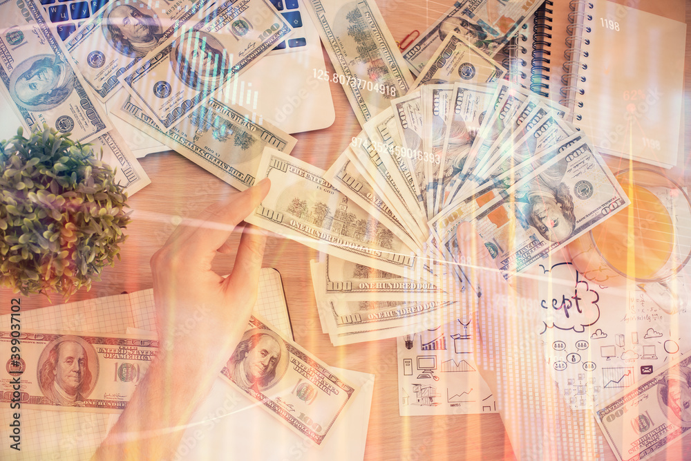 Multi exposure of financial graph drawing hologram and USA dollars bills and man hands. Analysis concept. Multi exposure of financial graph drawing hologram and USA dollars bills and man hands. Analysis concept.