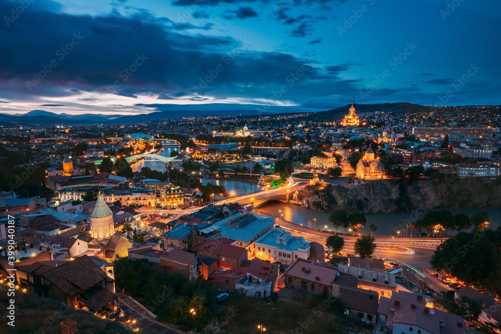 Tbilisi, Georgia. Evening Night View Of Georgian Capital Skyline. Scenic Top View Of Summer Evening Cityscape Of Tbilisi, Georgia In Illumination Lights With All Famous Landmarks, Sightseeings