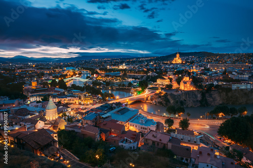 Tbilisi, Georgia. Evening Night View Of Georgian Capital Skyline. Scenic Top View Of Summer Evening Cityscape Of Tbilisi, Georgia In Illumination Lights With All Famous Landmarks, Sightseeings © Grigory Bruev