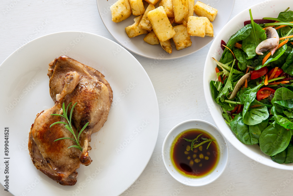 Duck leg confit with salad and potatoes Duck leg confit with salad and potatoes