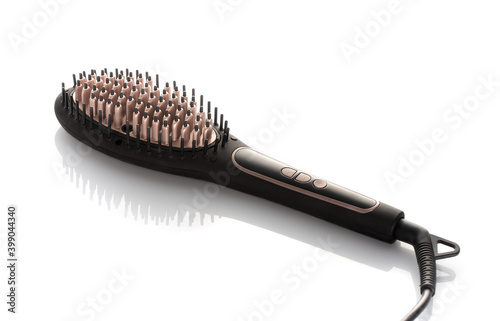 Close up of brand new hair brush for straightening hair. On white background.