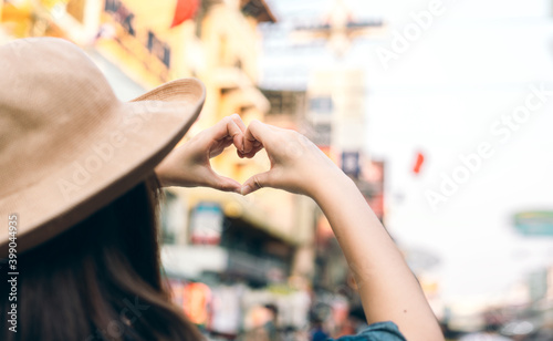 Asian traveller woman person hand with heart gesture.