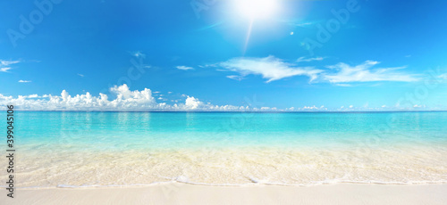 Fototapeta Naklejka Na Ścianę i Meble -  Beautiful sandy beach with white sand and rolling calm wave of turquoise ocean on Sunny day on background white clouds in blue sky. Island in Maldives, colorful perfect panoramic natural landscape.