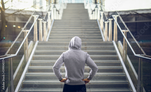 Man in hoodie preparing for stair run.