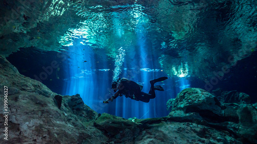 Cenote Tajma Ha with light rays Underwater in Yucatan, Mexico