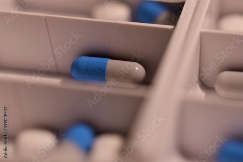 Close up of different pills prepared in tablets boxes