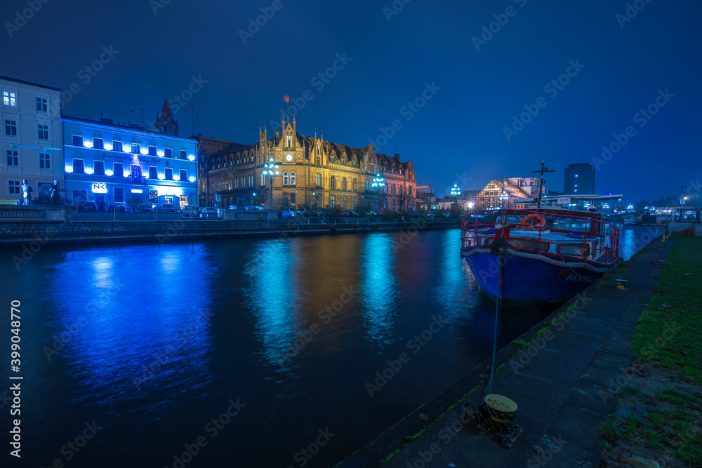 The architecture of the city of Bydgoszcz on the Brda River in the Kuyavian-Pomeranian Voivodeship in the evening time.