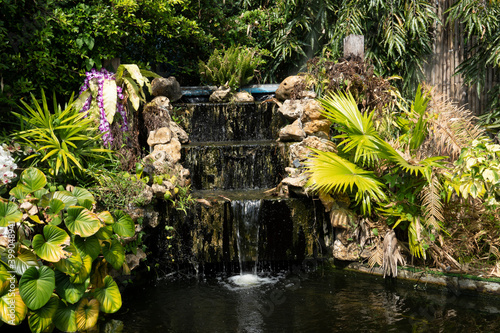 Pradit waterfall has three stages surrounded by green trees. photo