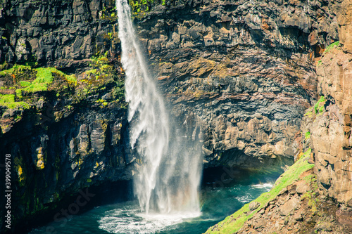 Faroes. Mulafossur waterfall in Gasadalur village in Faroe Islands  North Atlantic Ocean. Nordic Natural Landscape.