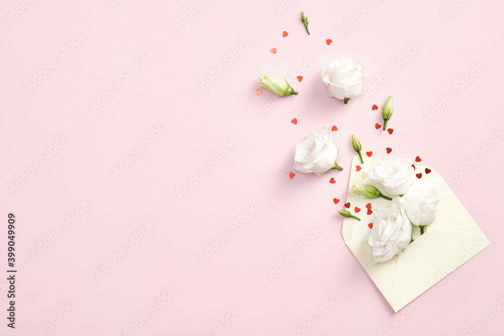 Flowers in envelope and red confetti on pink background. Flat lay, top view, copy space. Love letter, romantic concept. Happy Valentines day greeting card design. Flowers in envelope and red confetti on pink background. Flat lay, top view, copy space. Love letter, romantic concept. Happy Valentines day greeting card design.