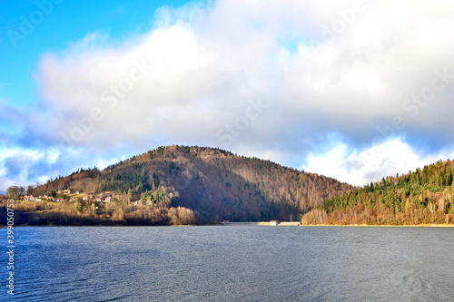 Sunset view of lake and 
dramatic sky with clouds over mountains in the background, 
Klimkowka Lake, Poland photo