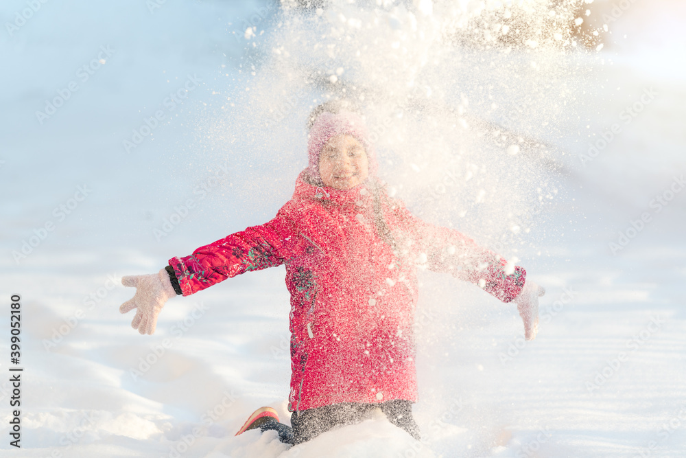 Winter, a girl plays outside throwing snow up Winter, a girl plays outside throwing snow up